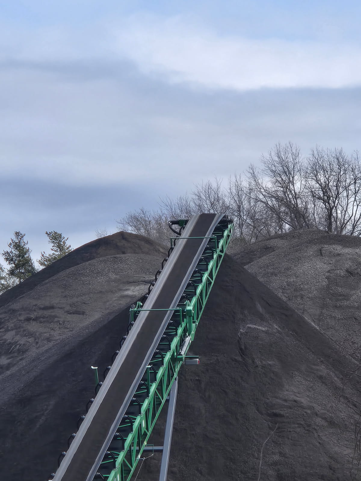 Gravel and aggregate piles at an excavation supply yard for construction and site development projects.
